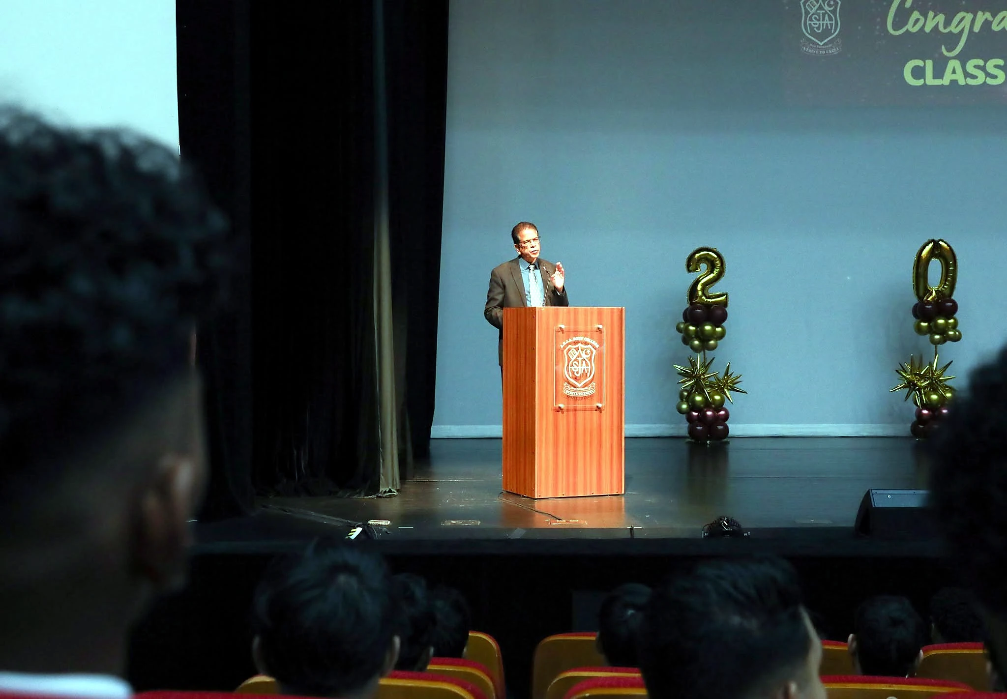 Minister Dowlath speaking on stage during the ceremony