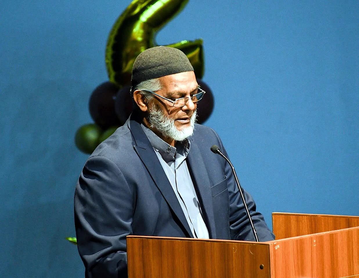 Mr. Hajji Ahmad Hosein addressing the ceremony from the podium